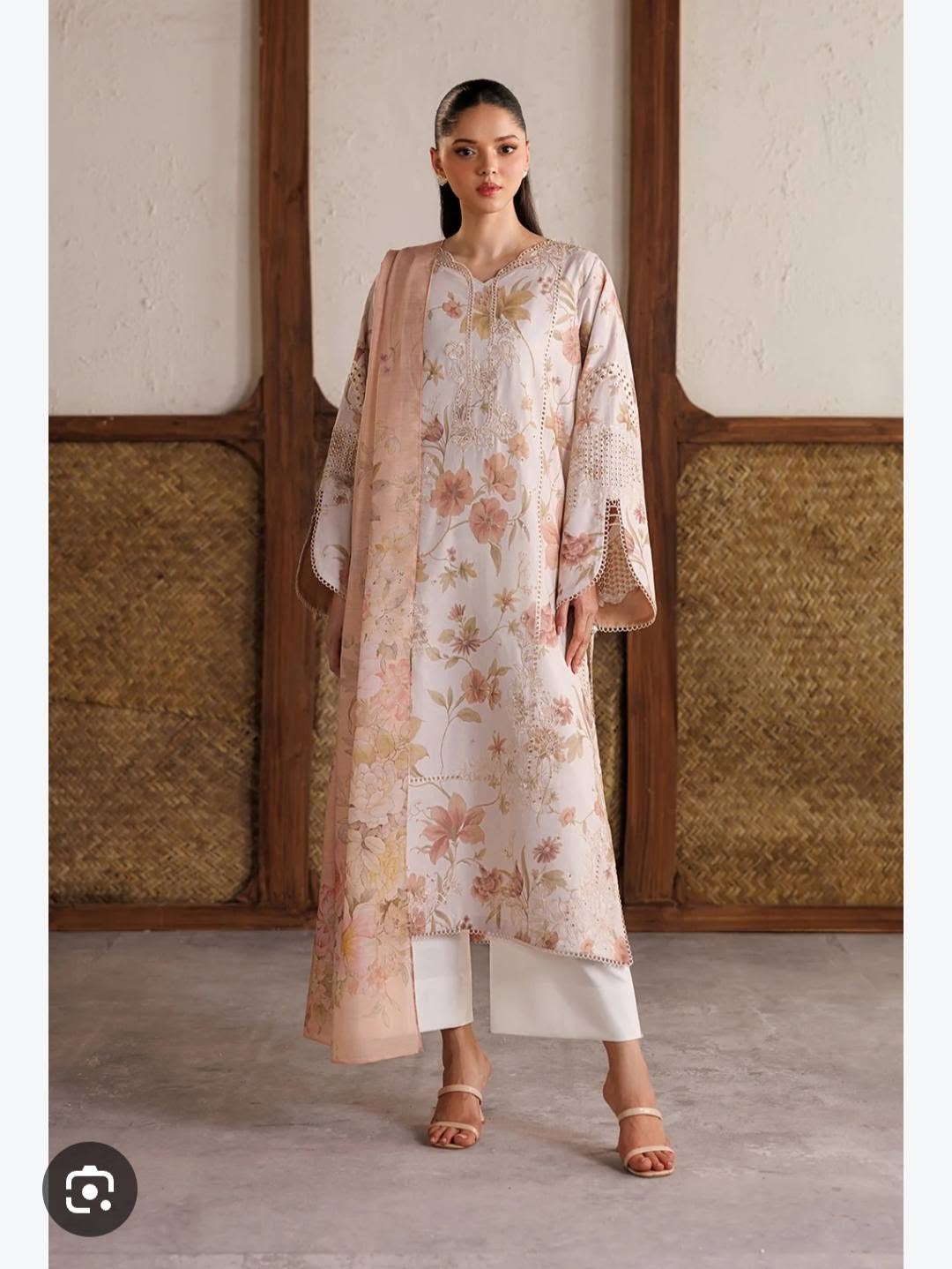 Delicate floral detailing on a pale pink suit